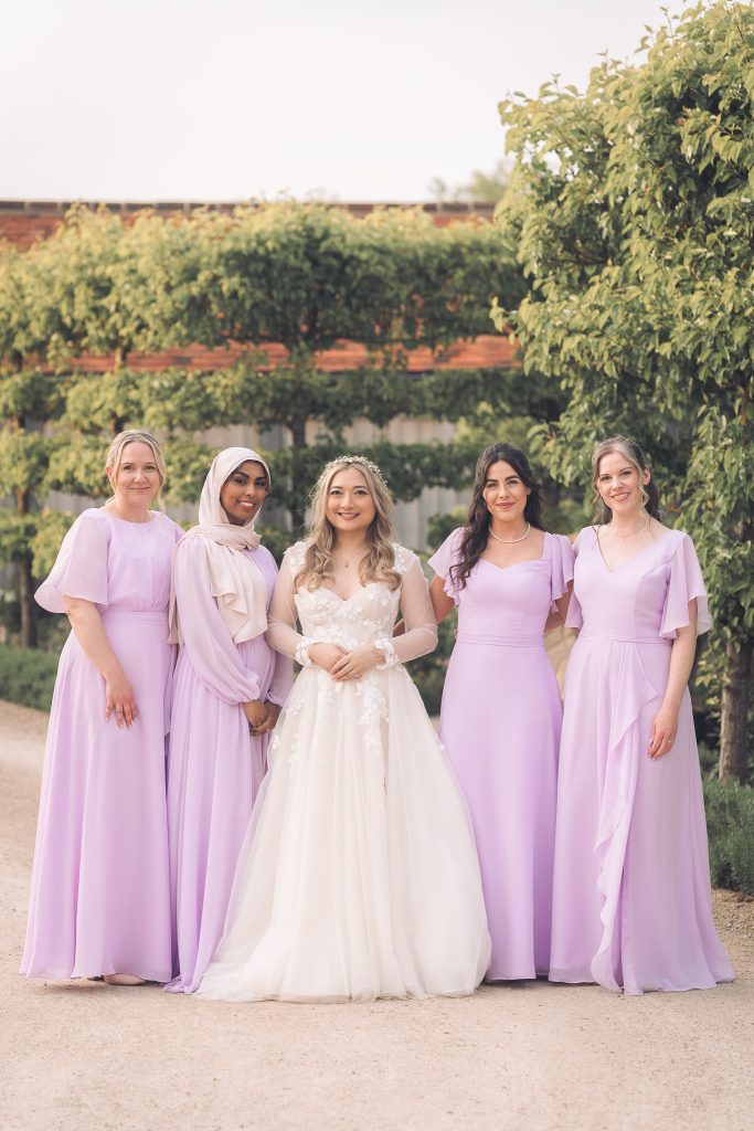 Lilac bridesmaid with bride in ellie sanderson wedding dress